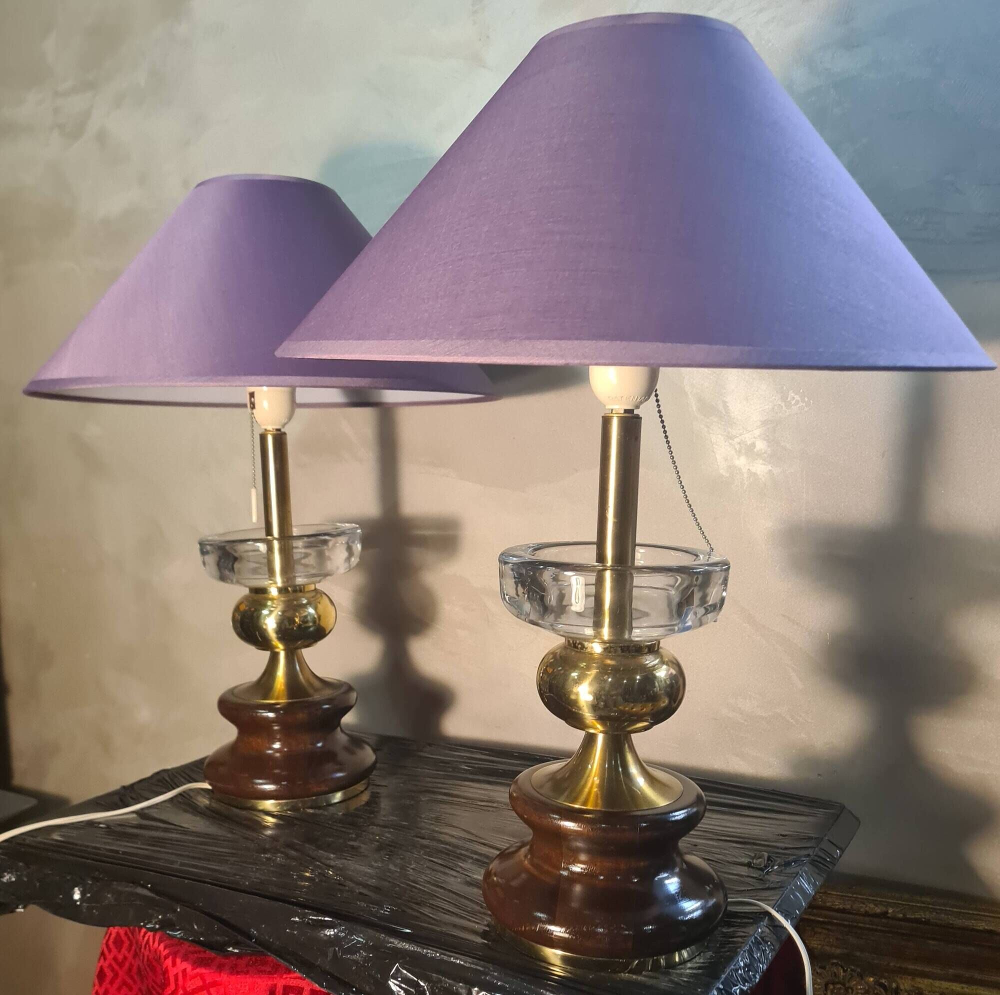 A pair of vintage table lamps featuring a turned wooden base, accessories...