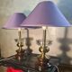 A pair of vintage table lamps featuring a turned wooden base, accessories...