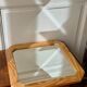 Octagonal mirror in light wood with grooves.