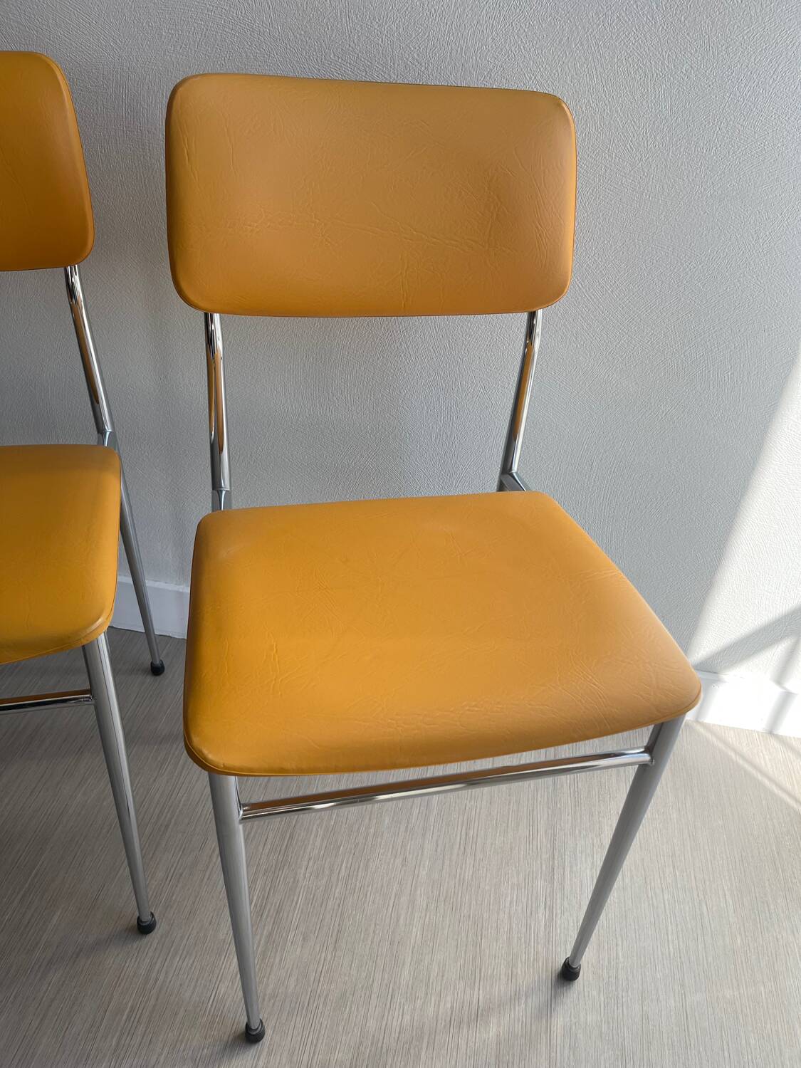 LM vintage chrome and orange/mustard yellow faux leather chairs