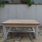 Coffee table with pearl grey legs and a wooden top.