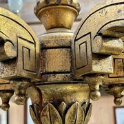 Golden wooden chandelier with crystal pendants from the 19th century.