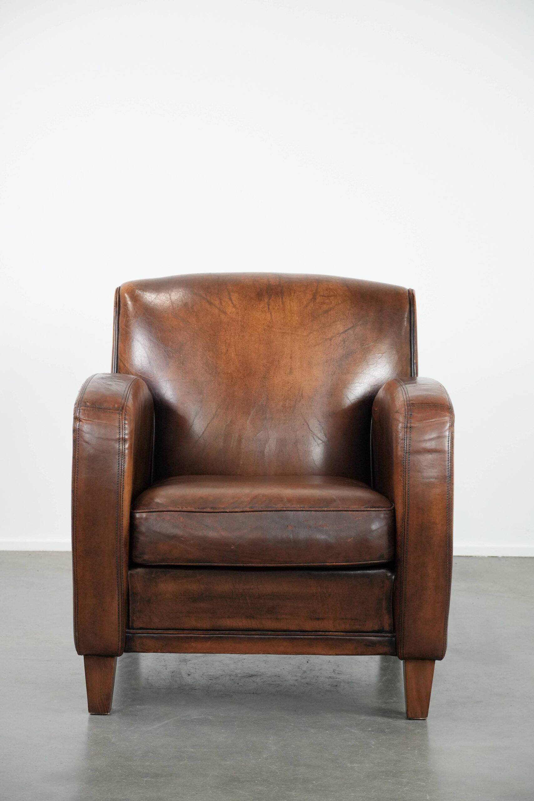 Characterful vintage sheepskin leather armchair with beautiful colours