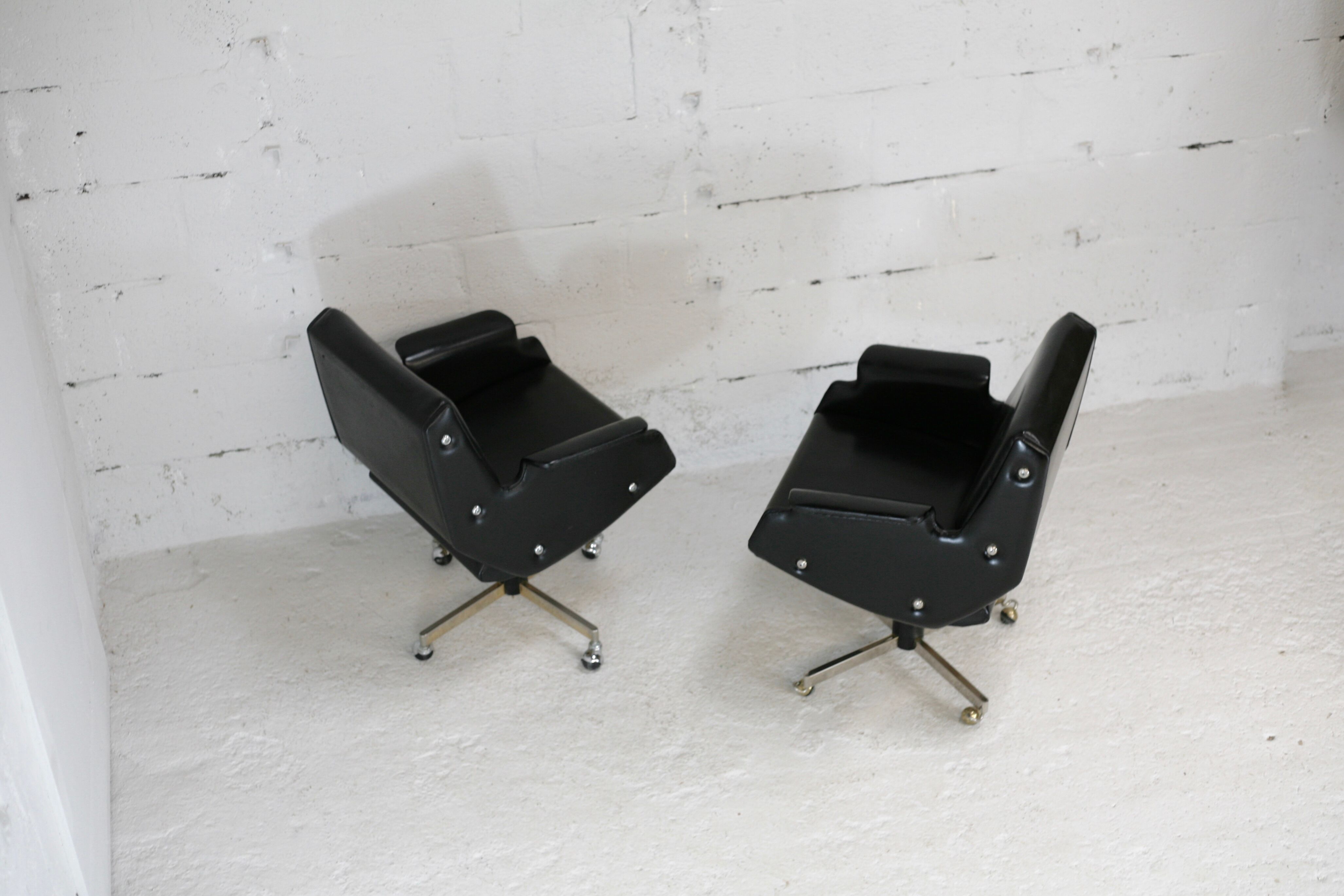 Pair of swivel armchairs, imitation leather and steel, Italy, circa 1960.