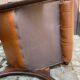 Chesterfield armchair in leather and carved solid wood