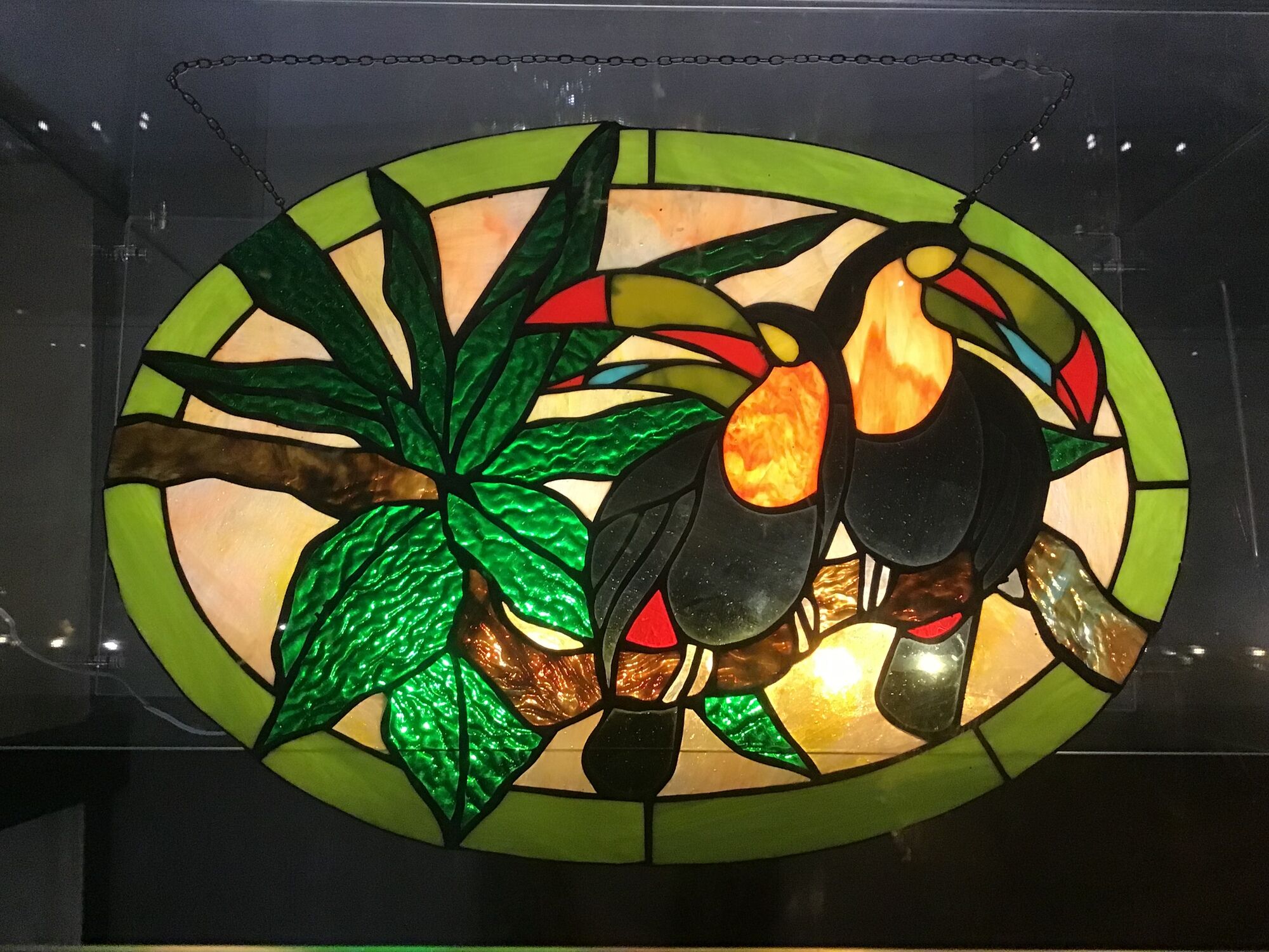 Art Deco style stained glass window representing a couple of toucans