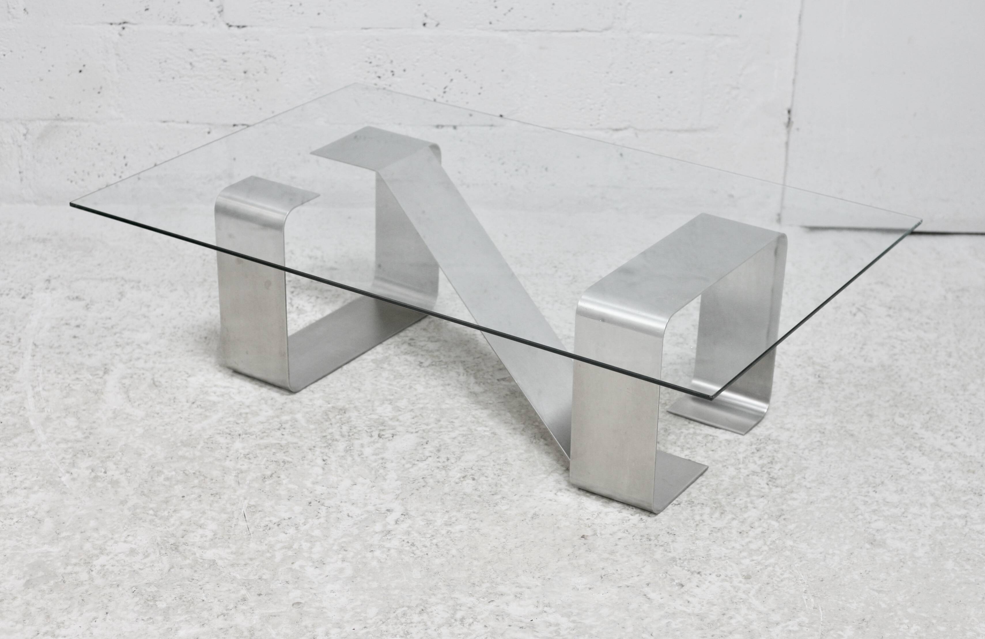 Coffee table with "kinetic" steel base and glass slab. Circa 1970.