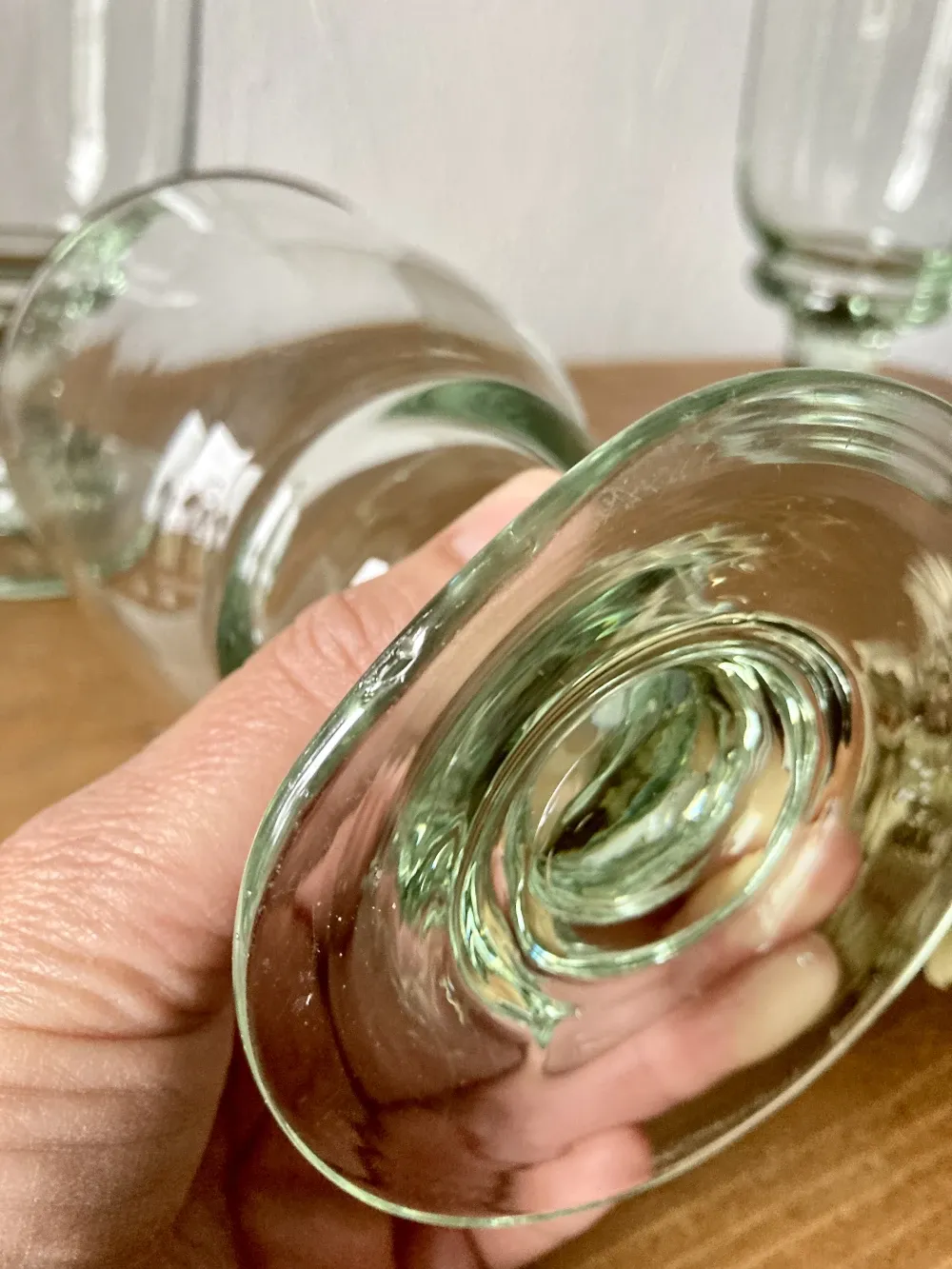4 stemmed glasses made of handcrafted blown glass in green hue.