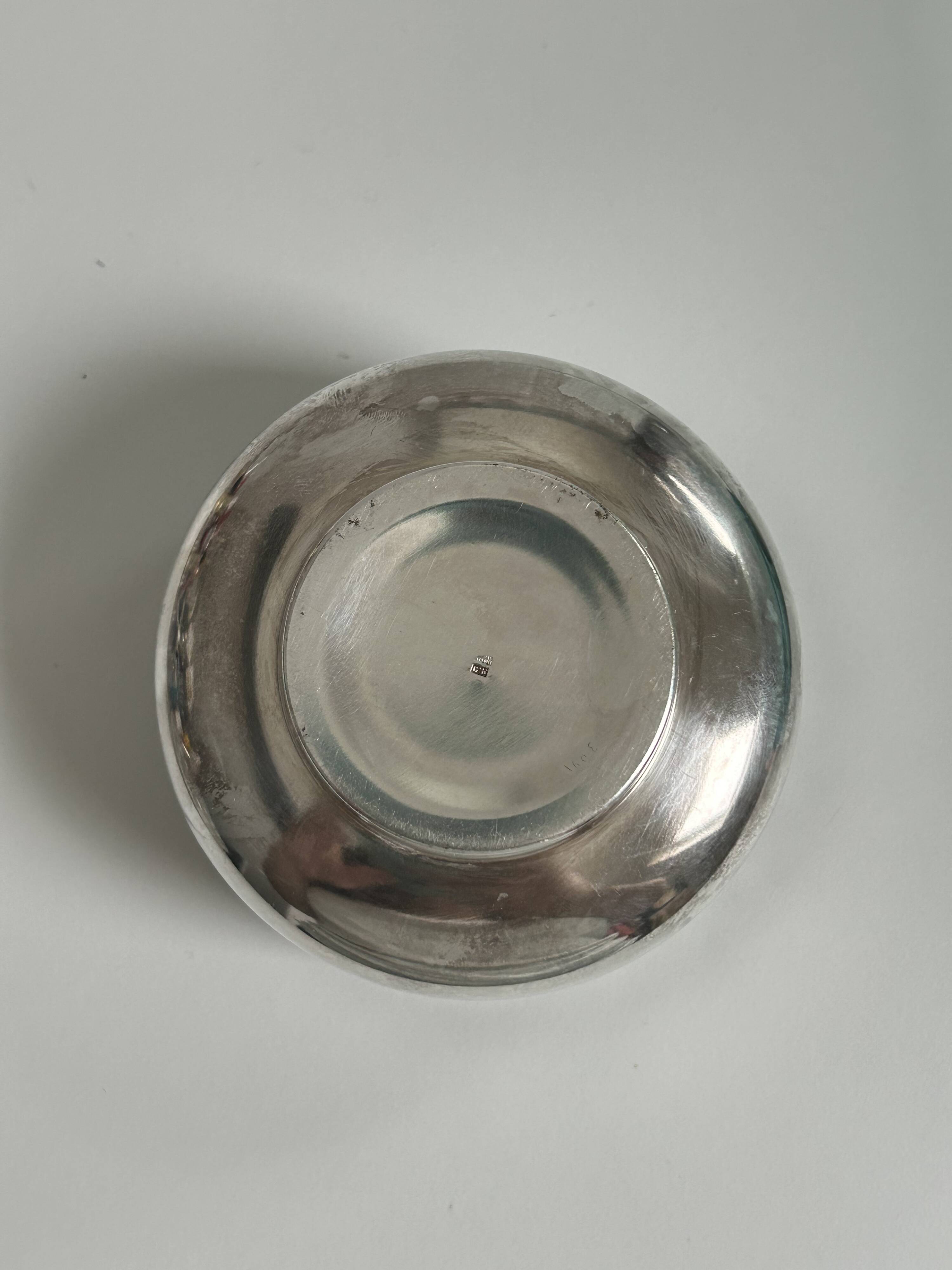 Vintage silver cup with a glass interior.