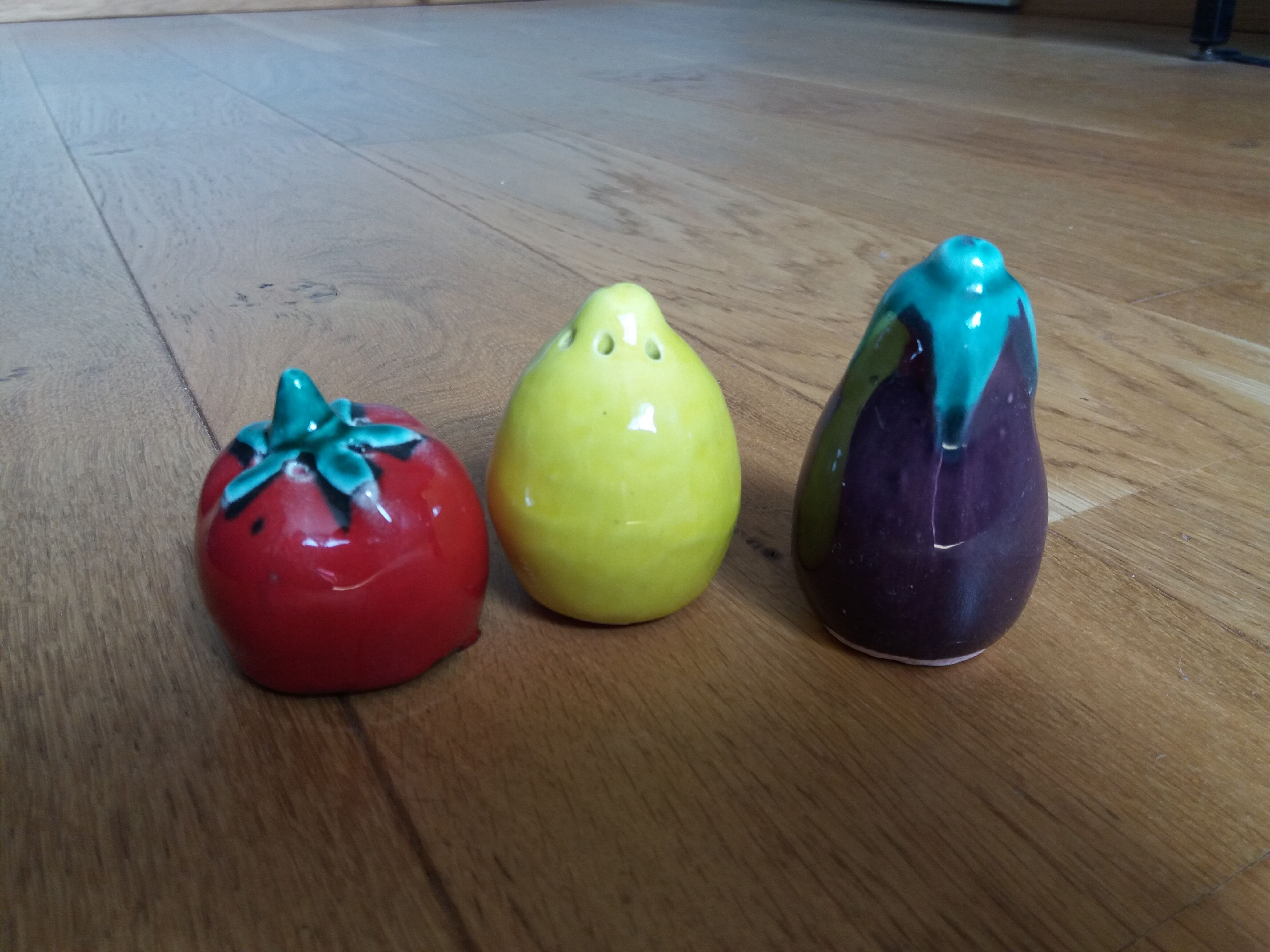 Trio salt shakers pepper vegetables and fruits in slip