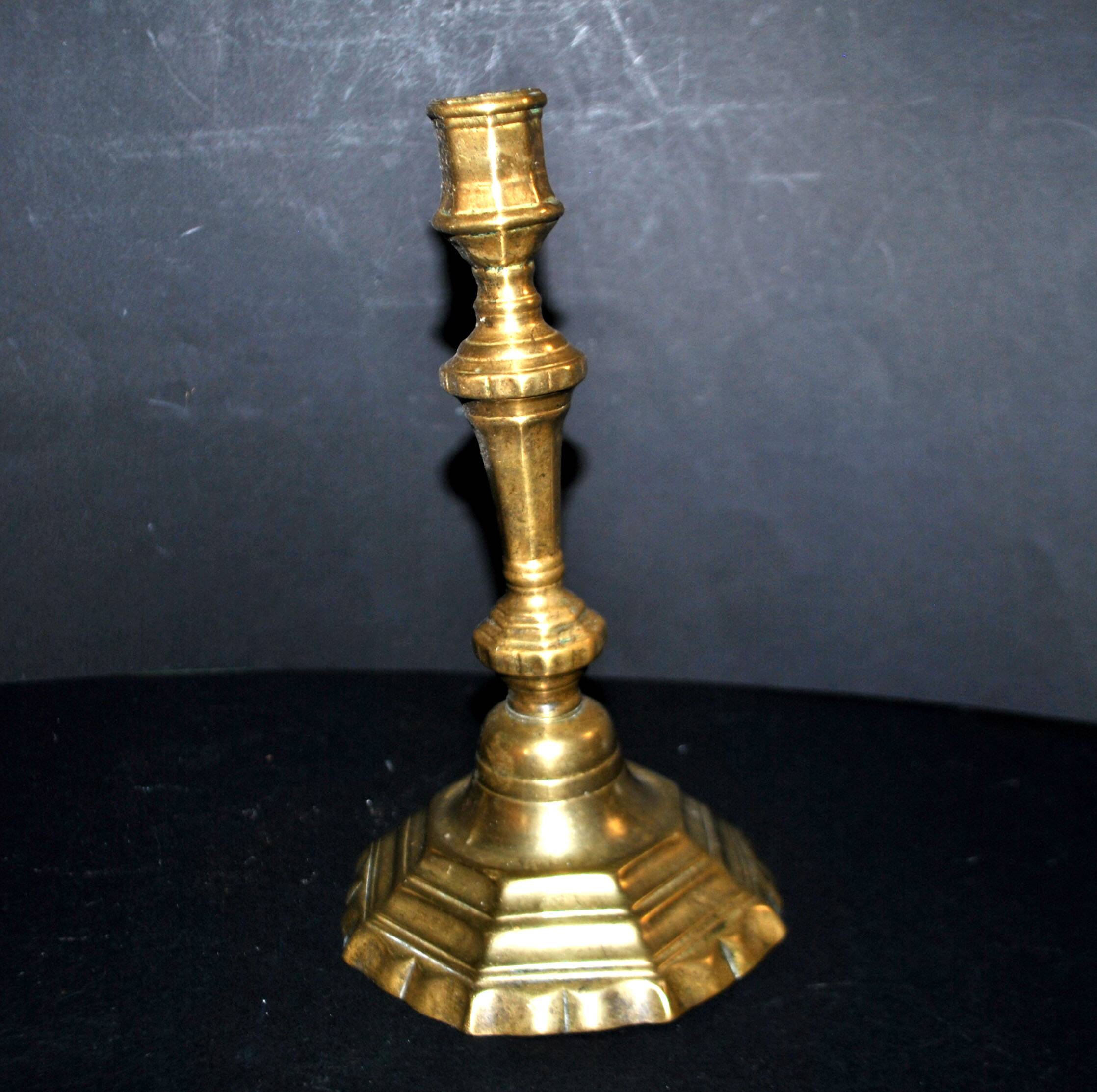 Antique 18th-century octagonal cut-out bronze candlestick in the Louis XIV style.