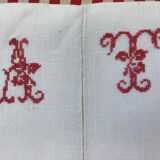 Sheet marked AT in red cross stitch