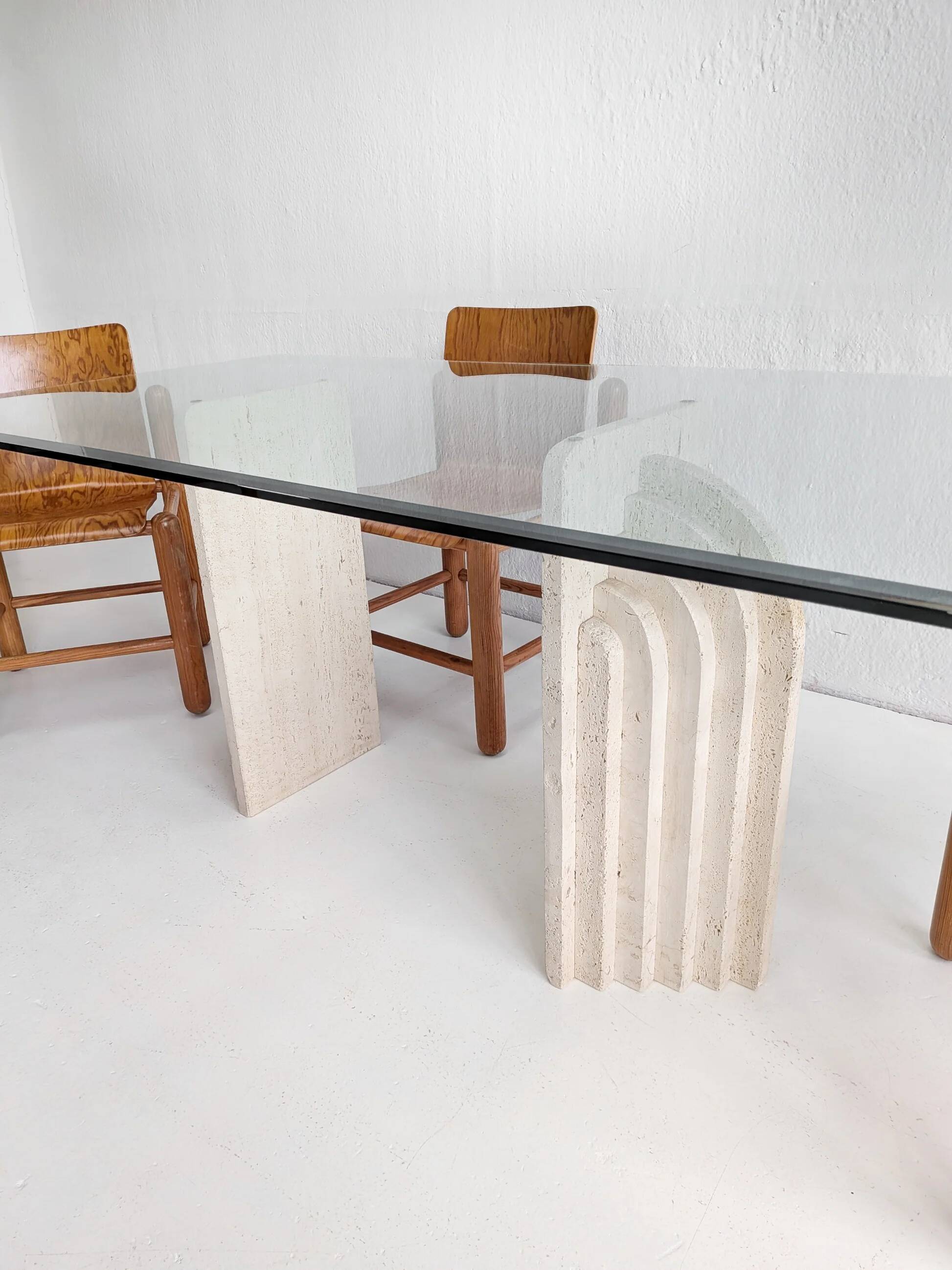 Dining table in travertine and glass with sculpted legs, 1970s.