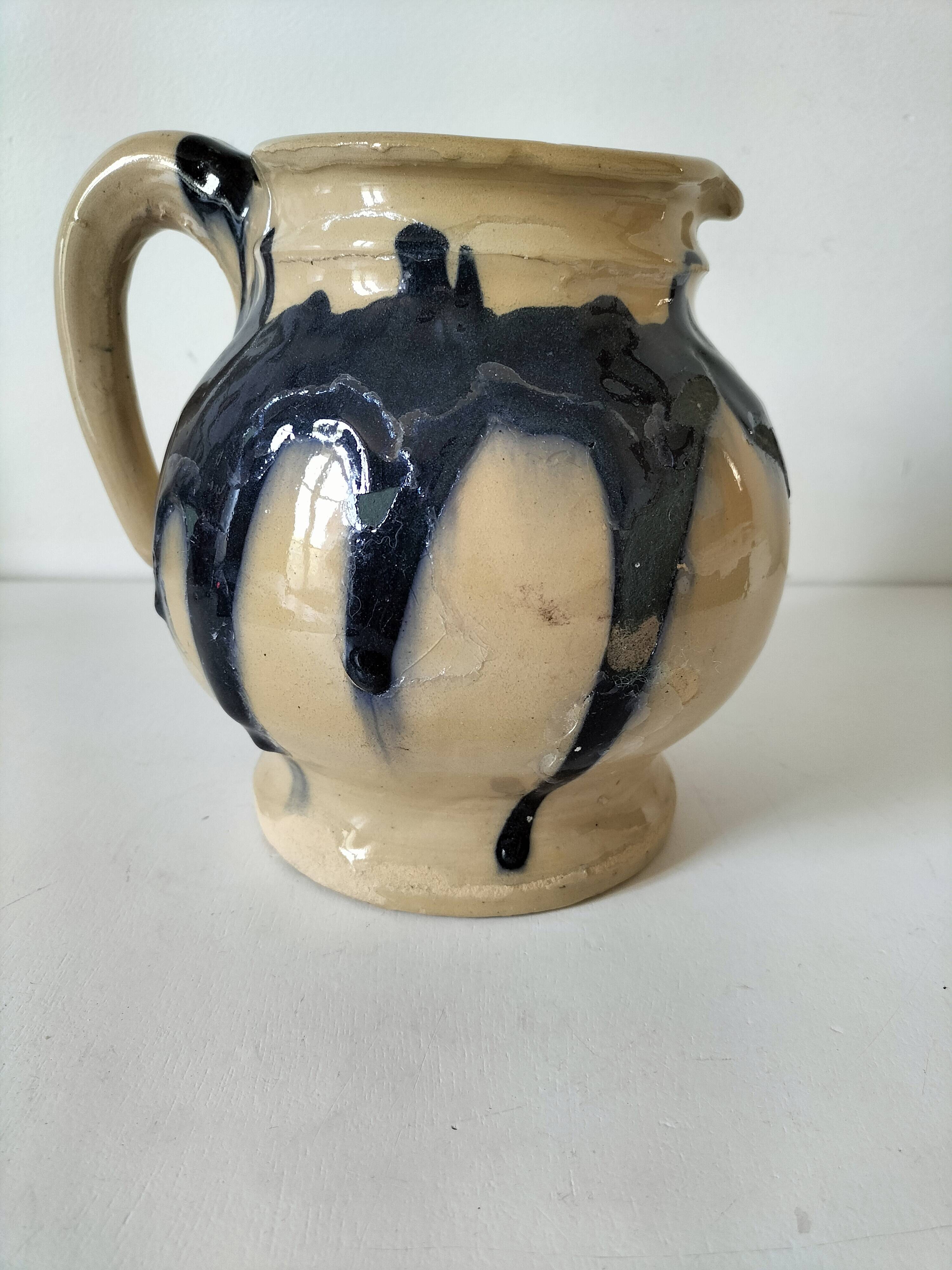 handcrafted ceramic jug with navy blue drip glaze.