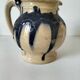 handcrafted ceramic jug with navy blue drip glaze.