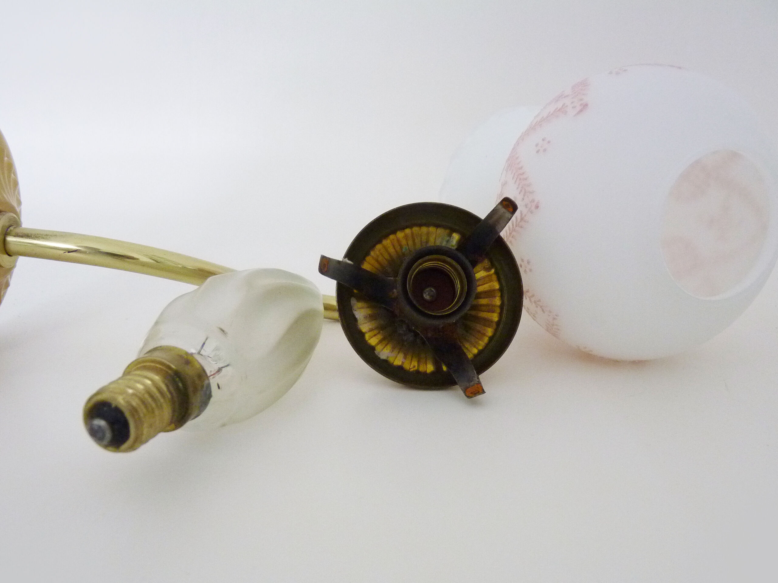 Pair of gooseneck wall sconces in gilded metal, white opaline with pink decorations