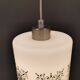 Scandinavian hanging lamp in white glass with inlayed black motifs.