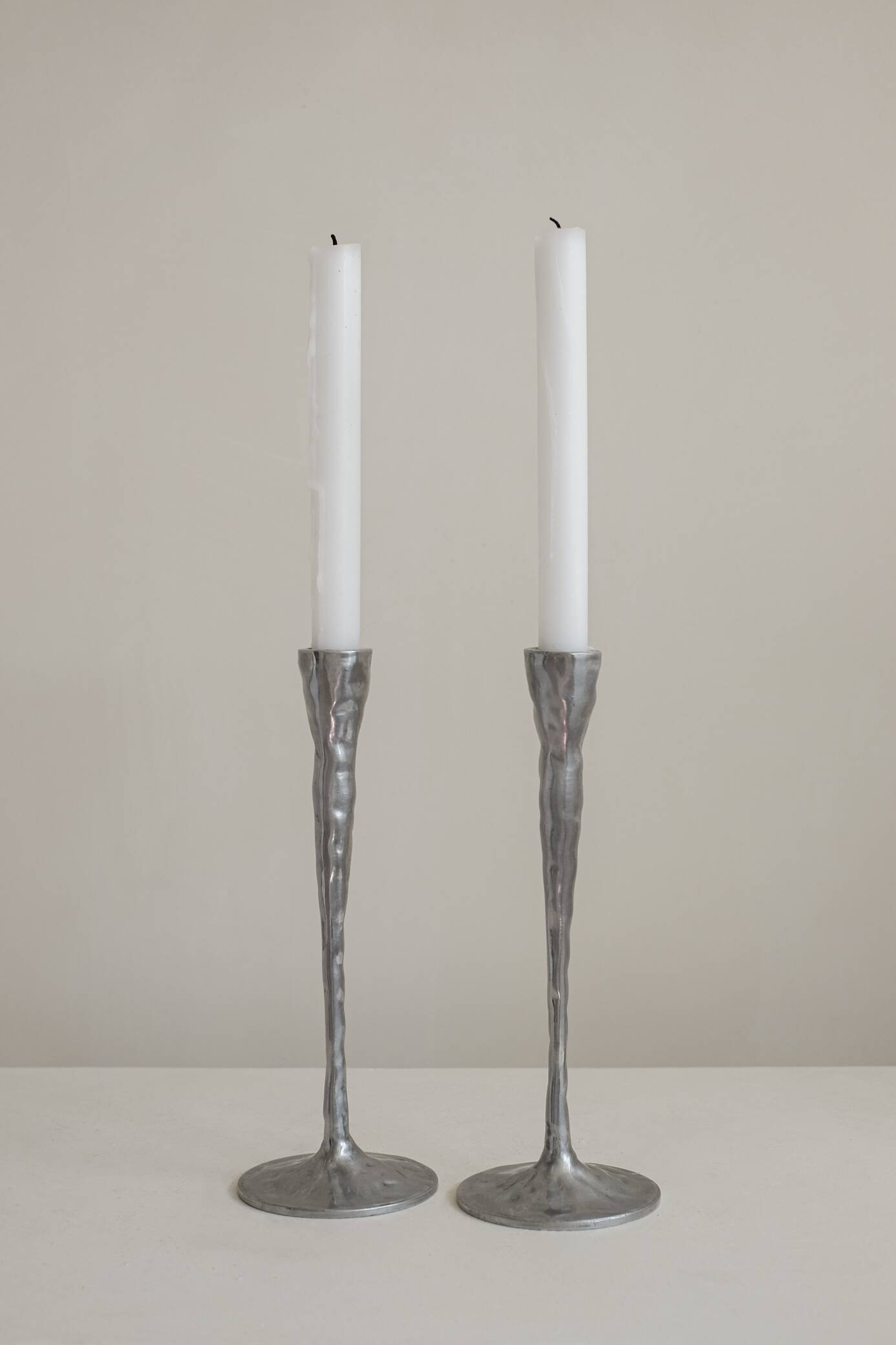 Pair of aluminium candle holders