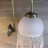 Brass swan neck wall lamp with pink glass globe and Charleston tassels