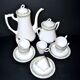 Vintage Limoges coffee service with pink and green floral decoration, coffee pot, sugar bowl, and 6 cups.