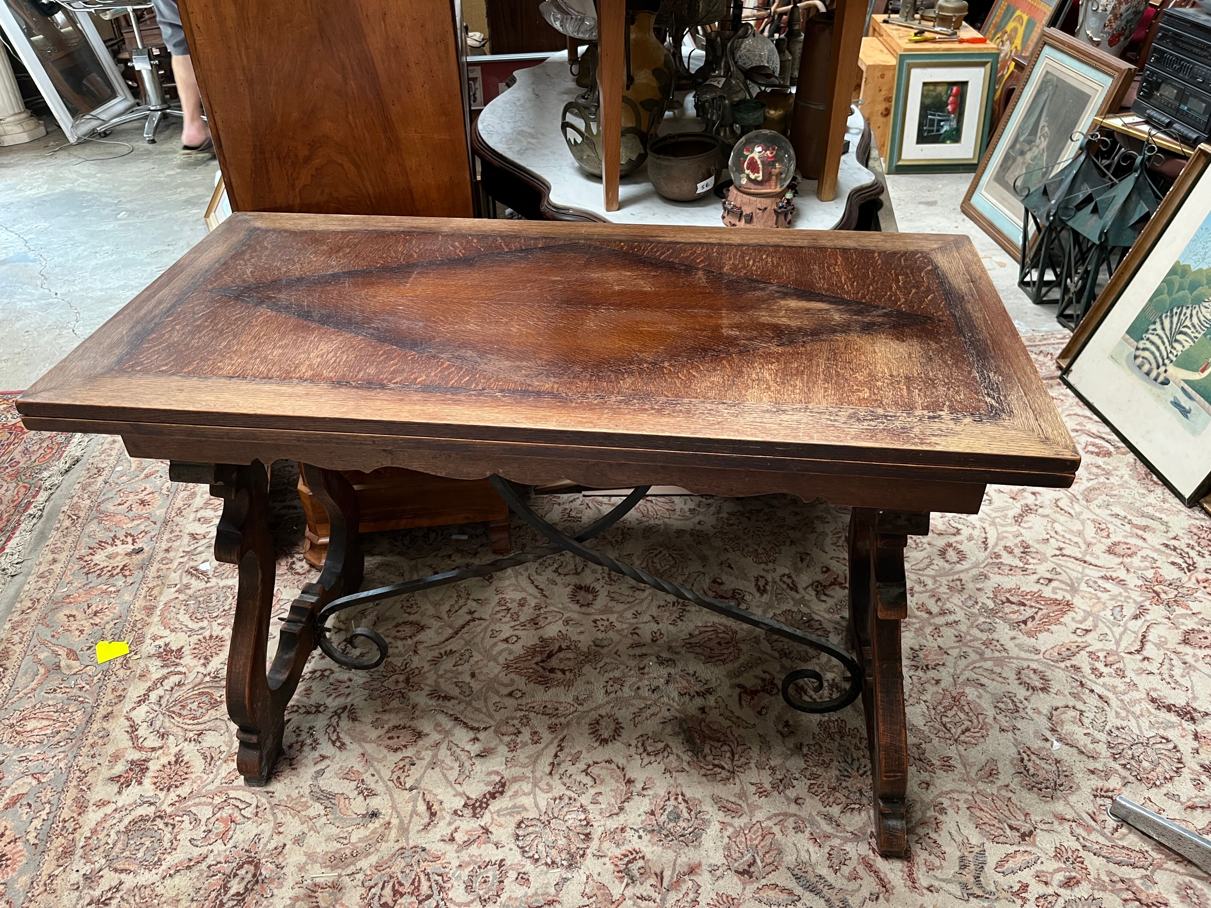 Spanish style table in carved wood and wrought iron