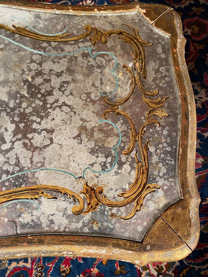 Louis XV style coffee table in carved wood with grey and gold highlights.