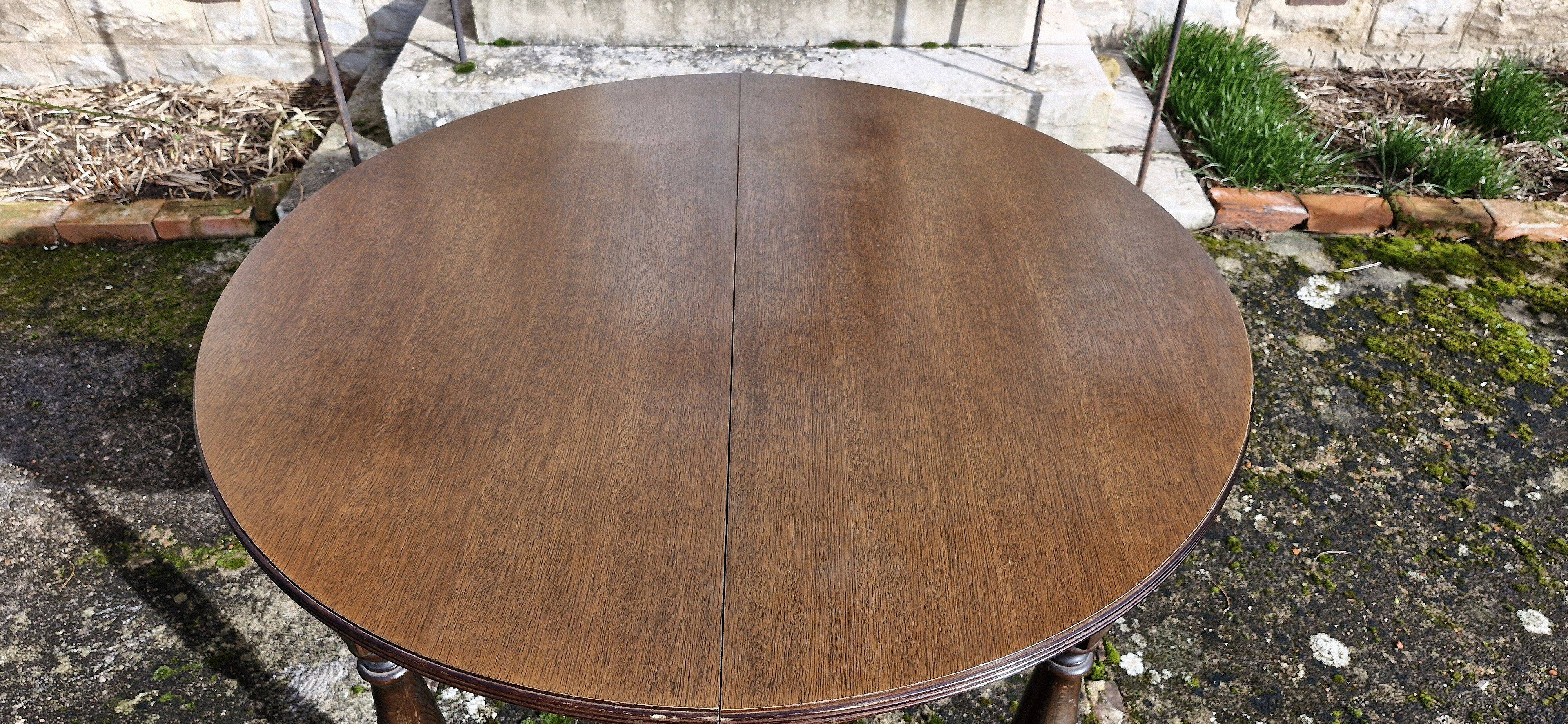 Round wooden table with 1 integrated extension + 6 wooden and fabric chairs