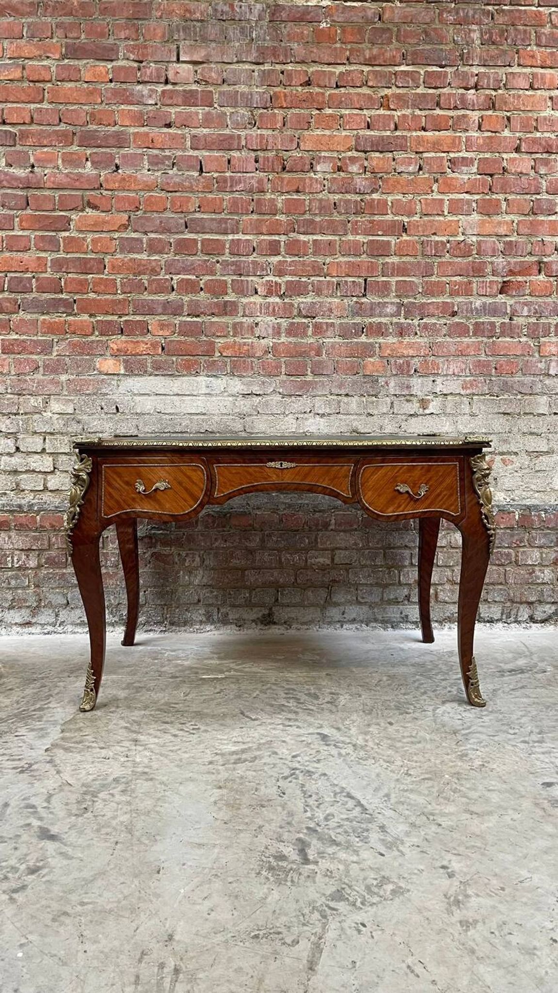 Antique French-style desk with green leather top and bronze mounts