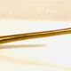 Antique candle extinguisher in golden brass
