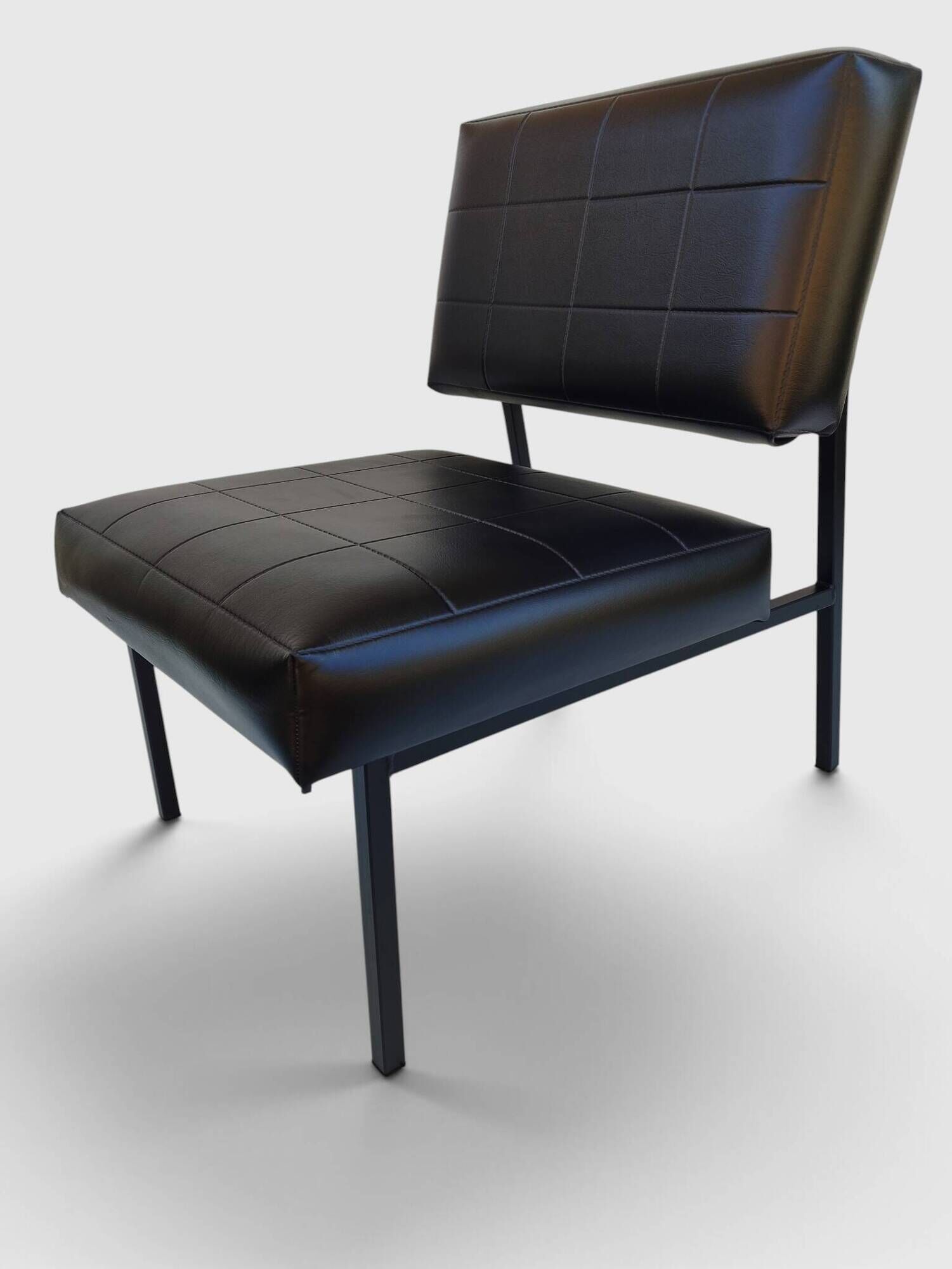 Modernist armchair in black faux leather and metal – 1960s