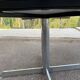 White dining table with a central pedestal, extendable, from the 1970s.
