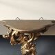 Small Italian/Baroque wall-mounted console. In gilded wood.