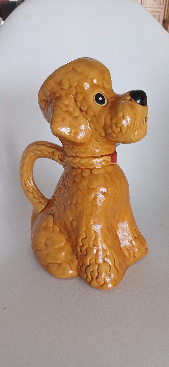 Ancient ceramic pitcher in the shape of a poodle.