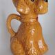 Ancient ceramic pitcher in the shape of a poodle.