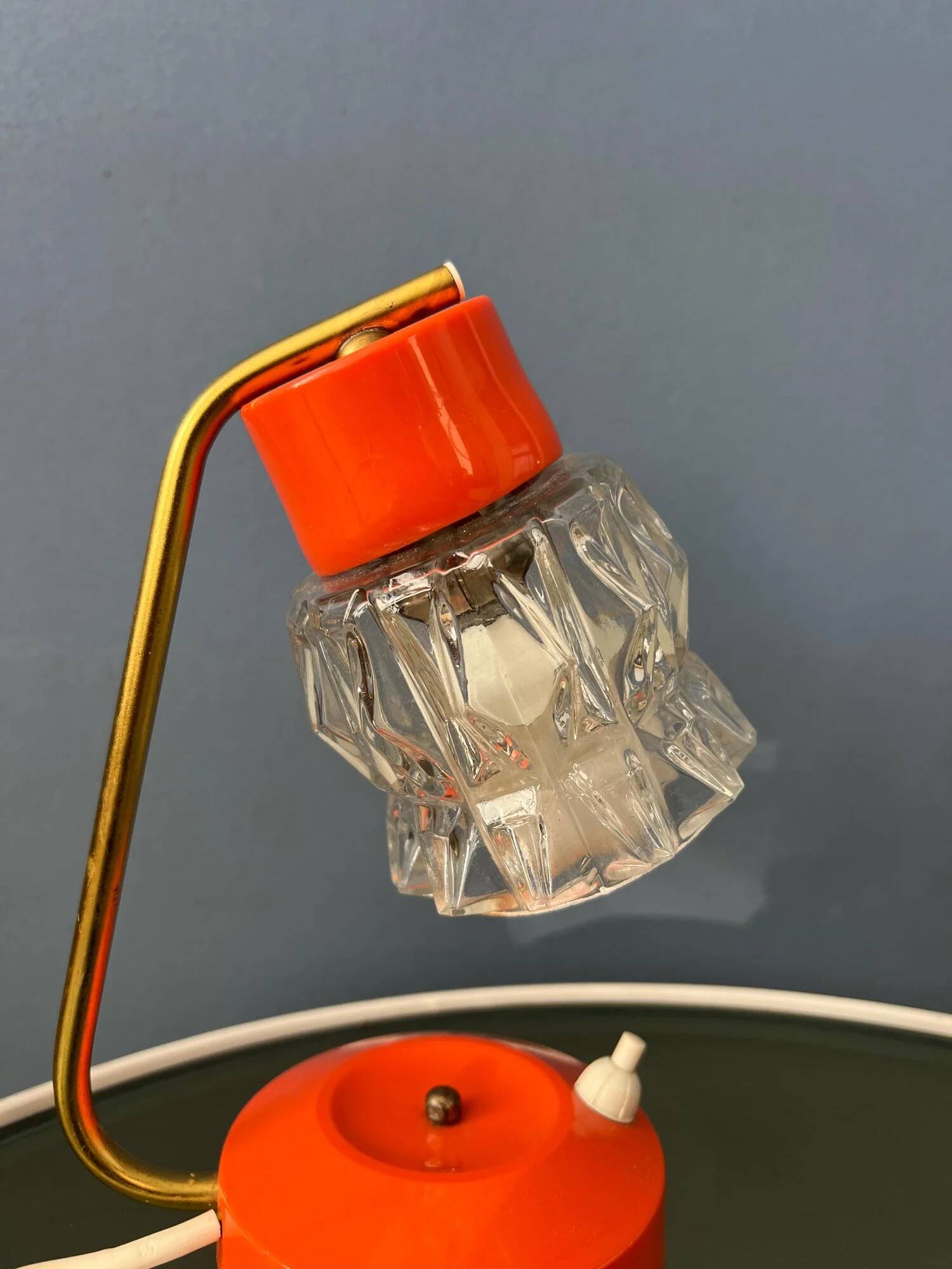 Small orange desk lamp with clear crystal glass shade