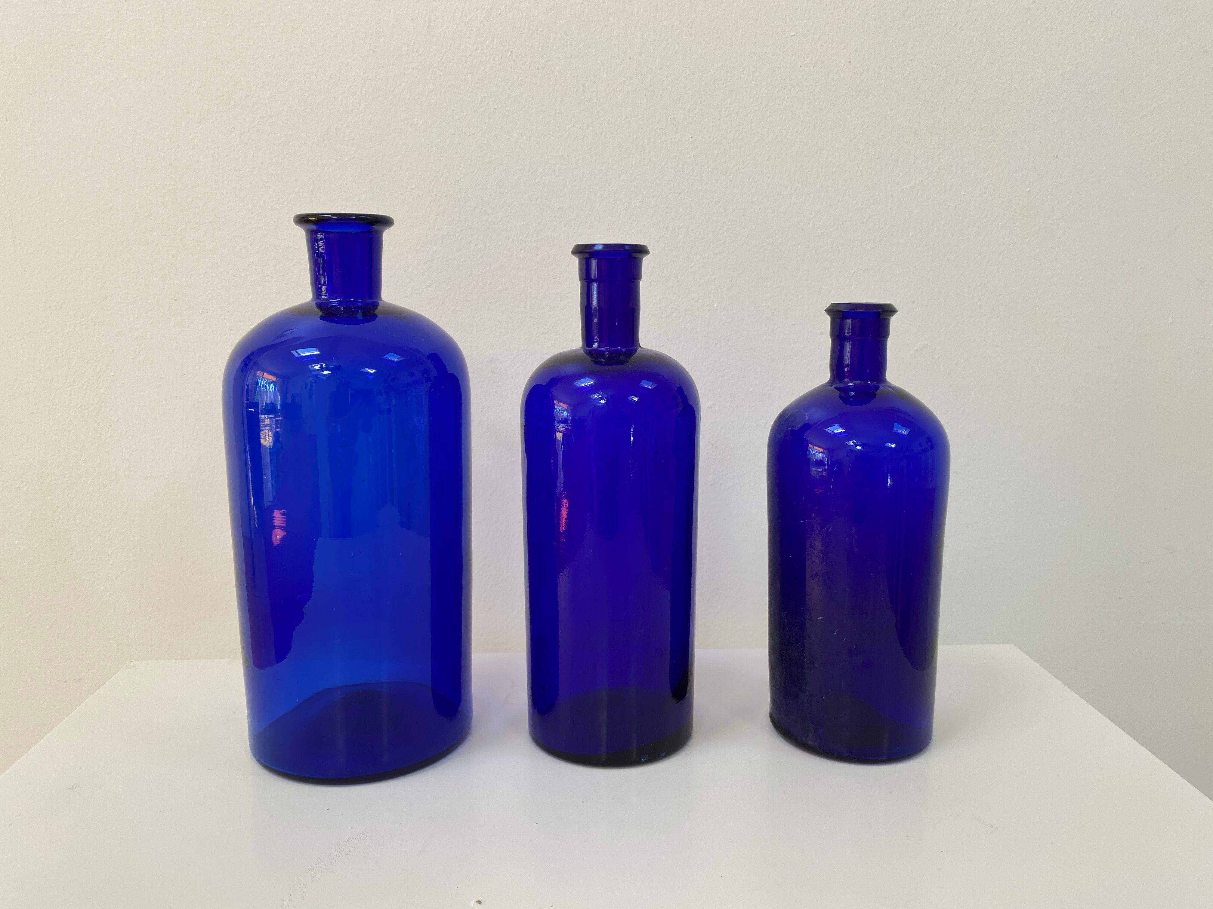 Trio of apothecary bottles in cobalt blue glass