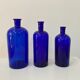 Trio of apothecary bottles in cobalt blue glass