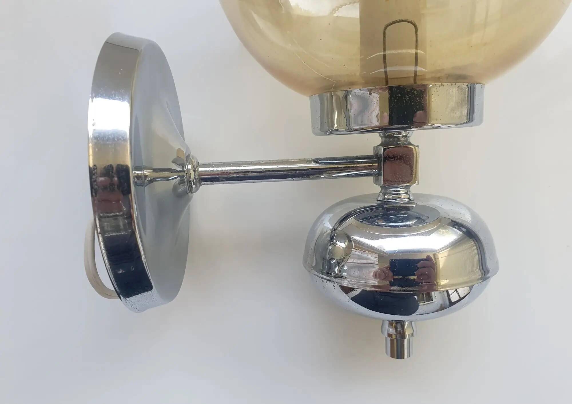 Pair of chrome metal wall lights with vintage sandblasted glass globes