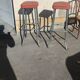 Pair of aluminum bar stools with orange and black seats