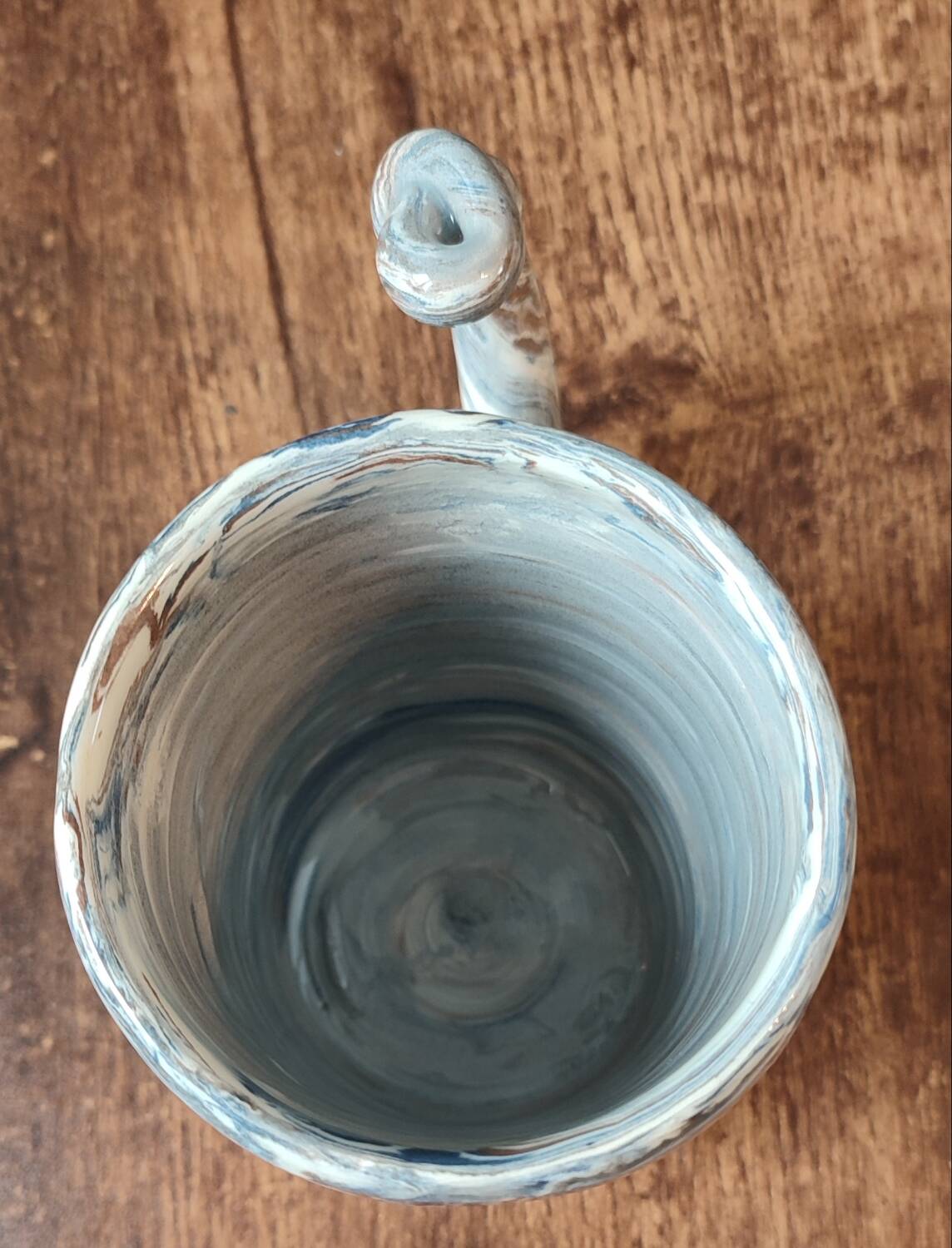 Handcrafted ceramic mug with marbled design, unique piece.