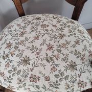 Pair of Provençal armchairs in brown wood and floral fabric.