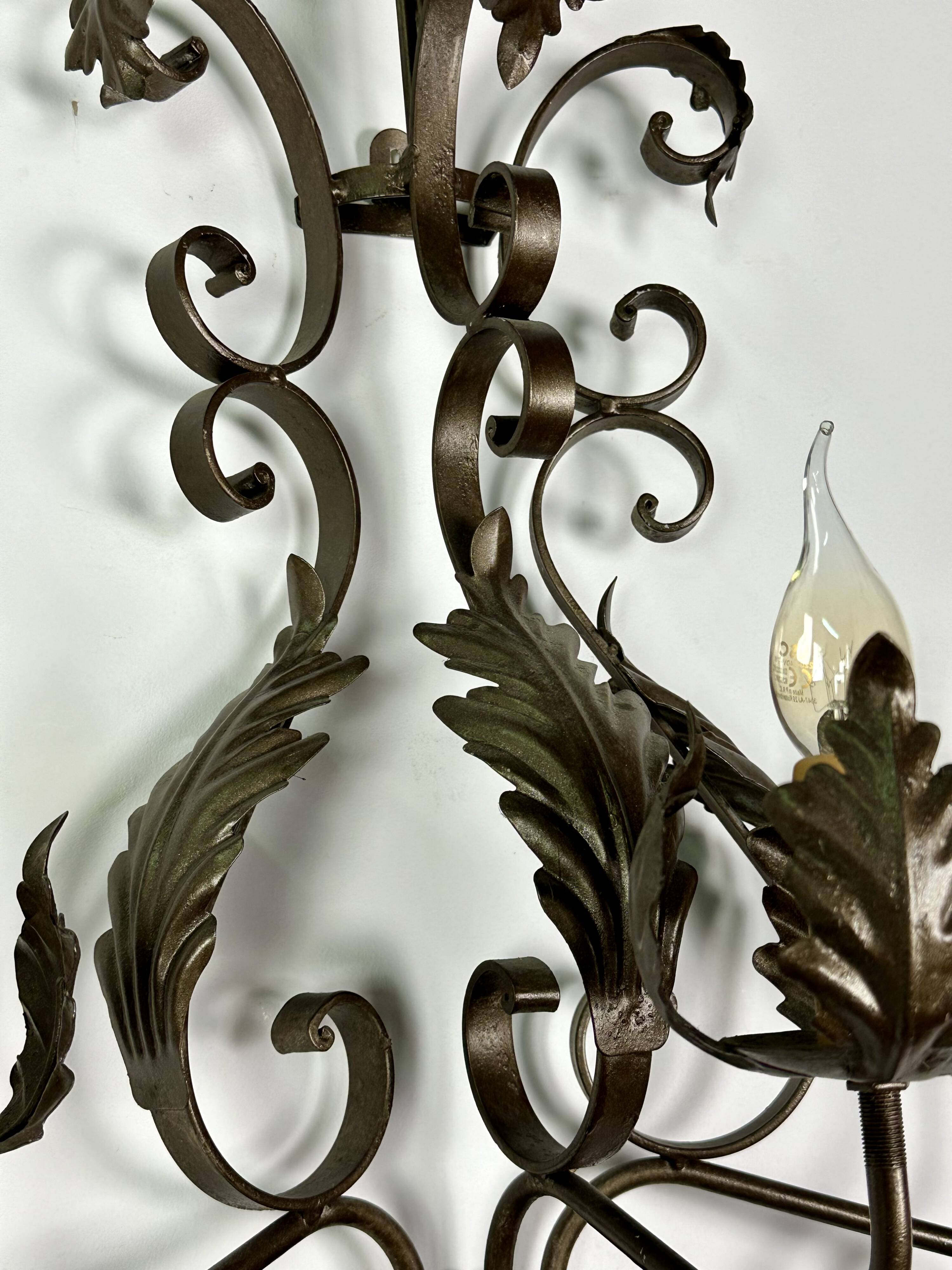 Wrought iron wall lights (pair) with foliage decoration