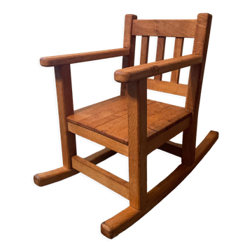 Old children's rocking chair in solid wood