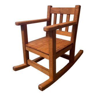 Old children's rocking chair in solid wood