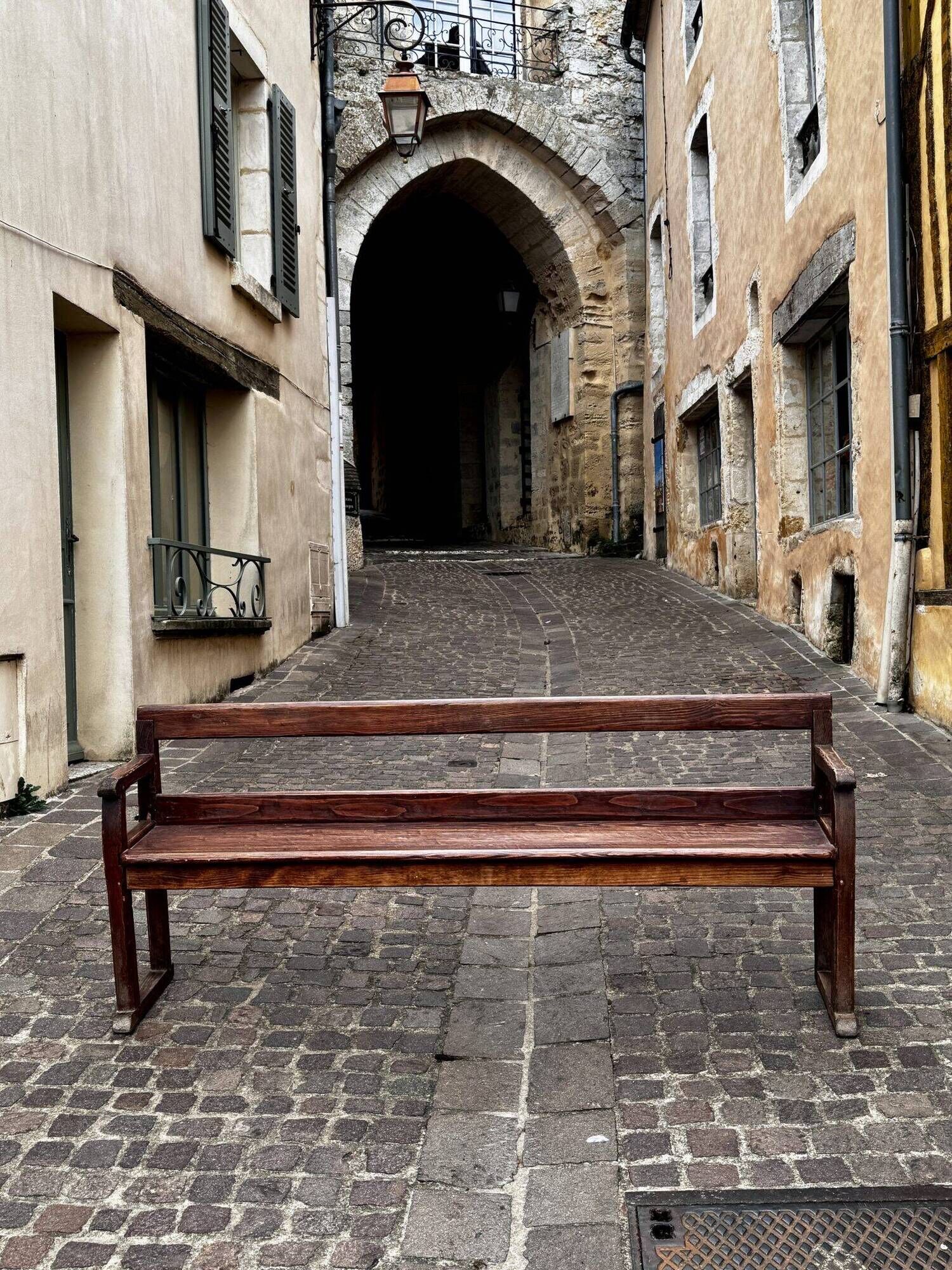 Old wooden bench with backrest and armrests
