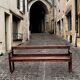 Old wooden bench with backrest and armrests