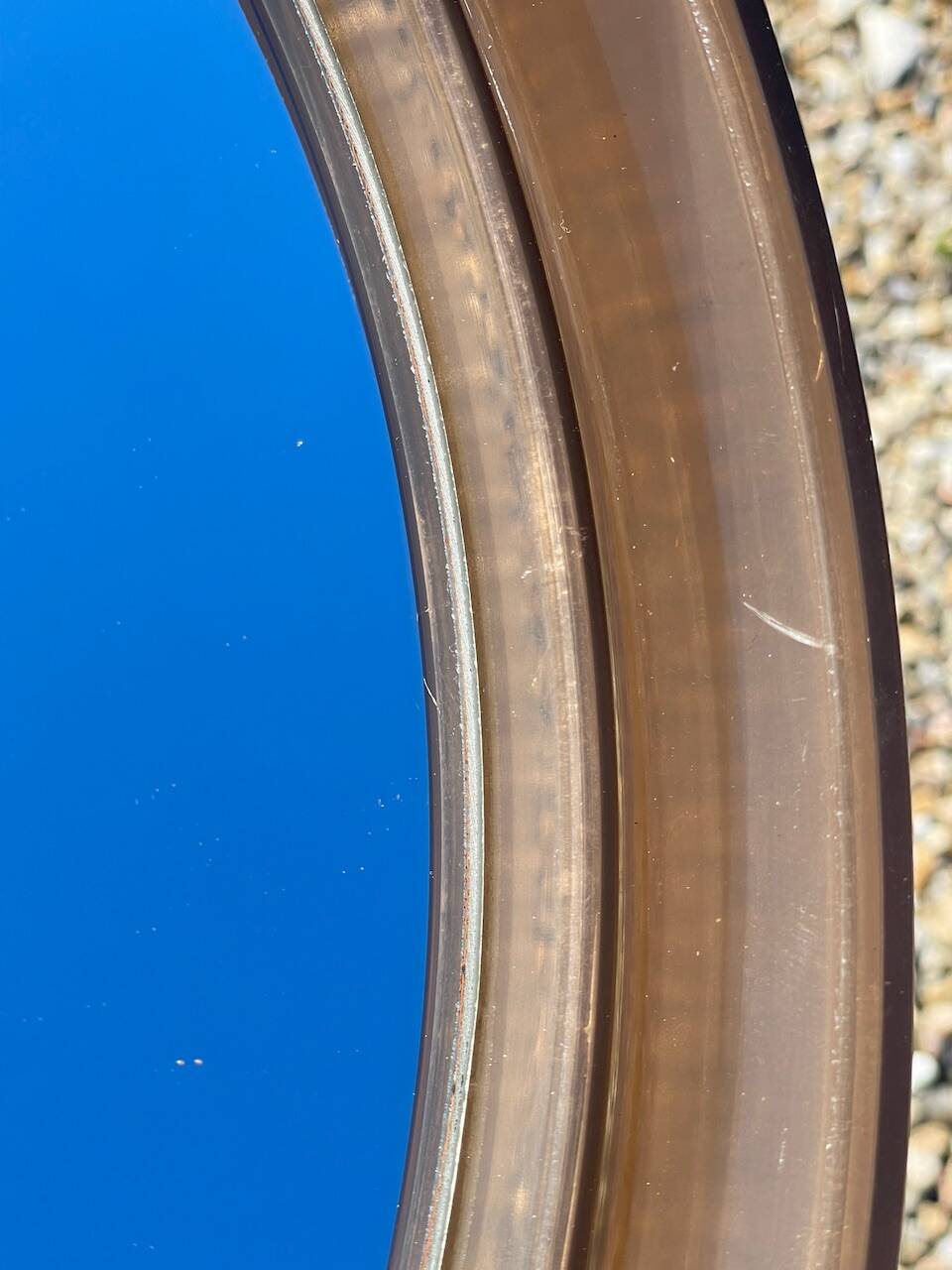 Vintage round smoked plastic mirror, circa 1970s.