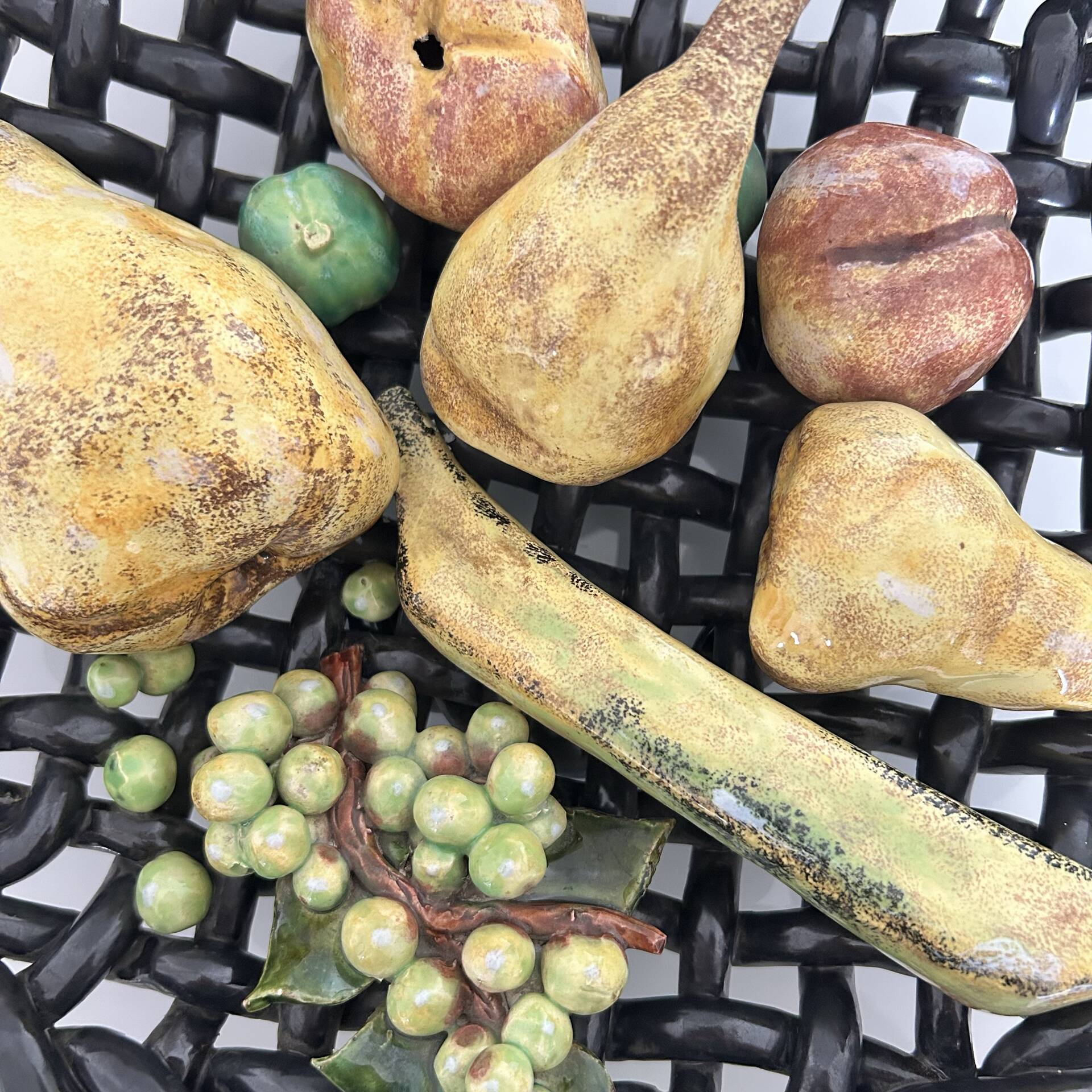 Large woven bowl and trompe l'œil fruits