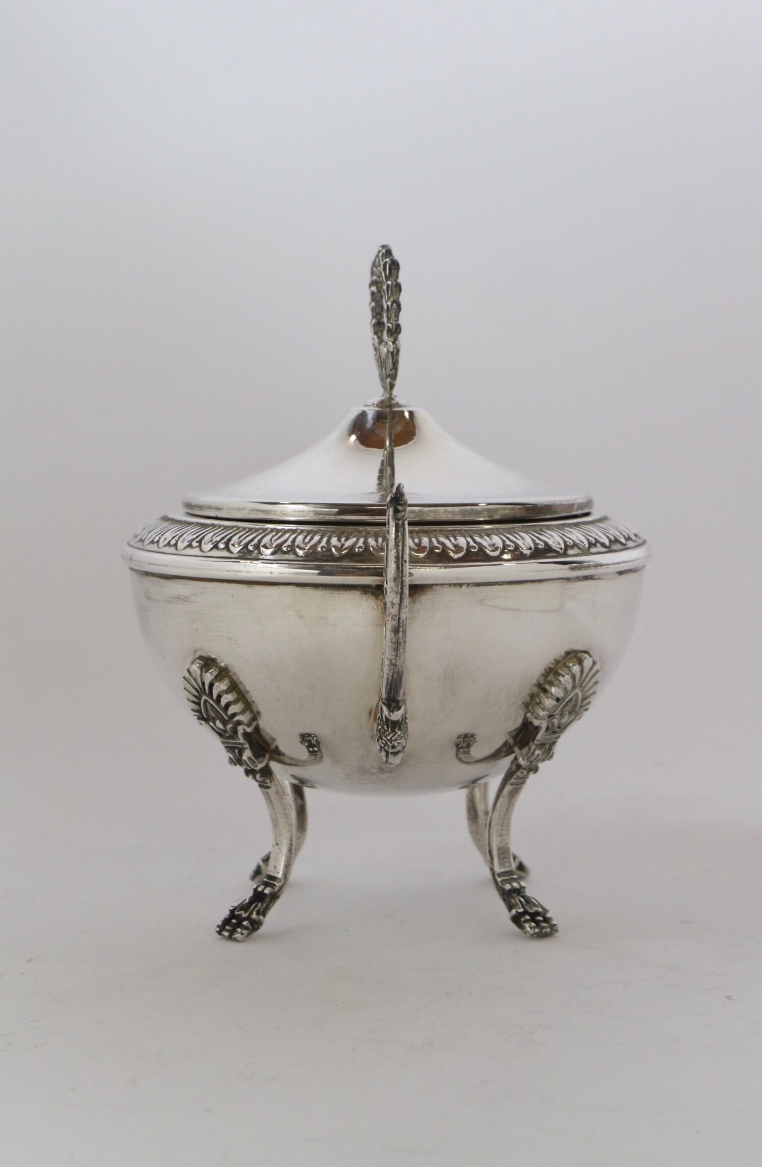 Silver sugar bowl with paw feet and ornate handles