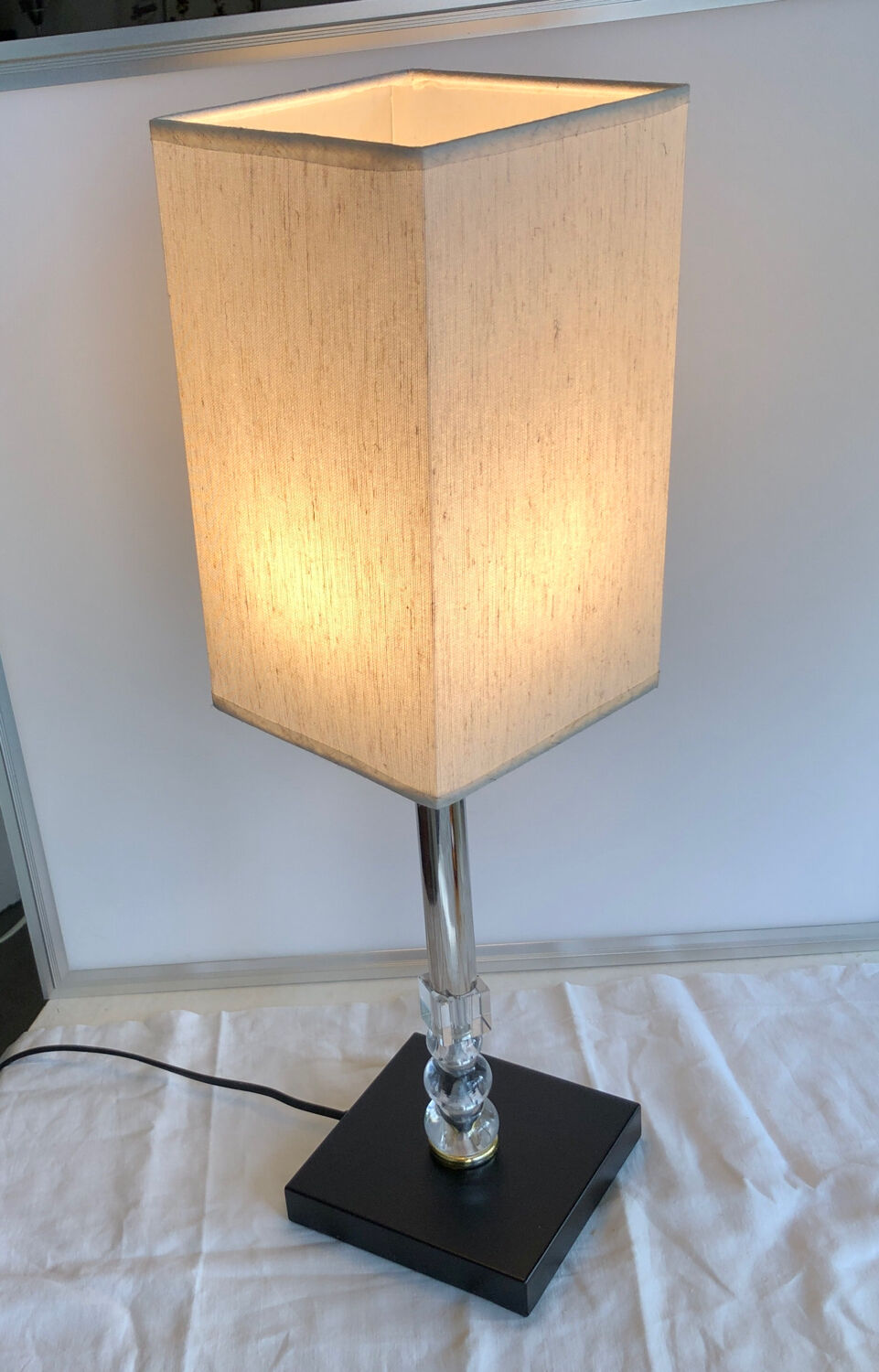 Silver floor lamp with a straight shade.
